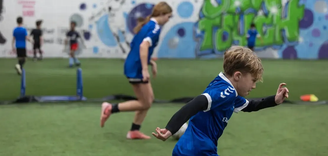 Campers playing a small-sided game during an Own Touch camp