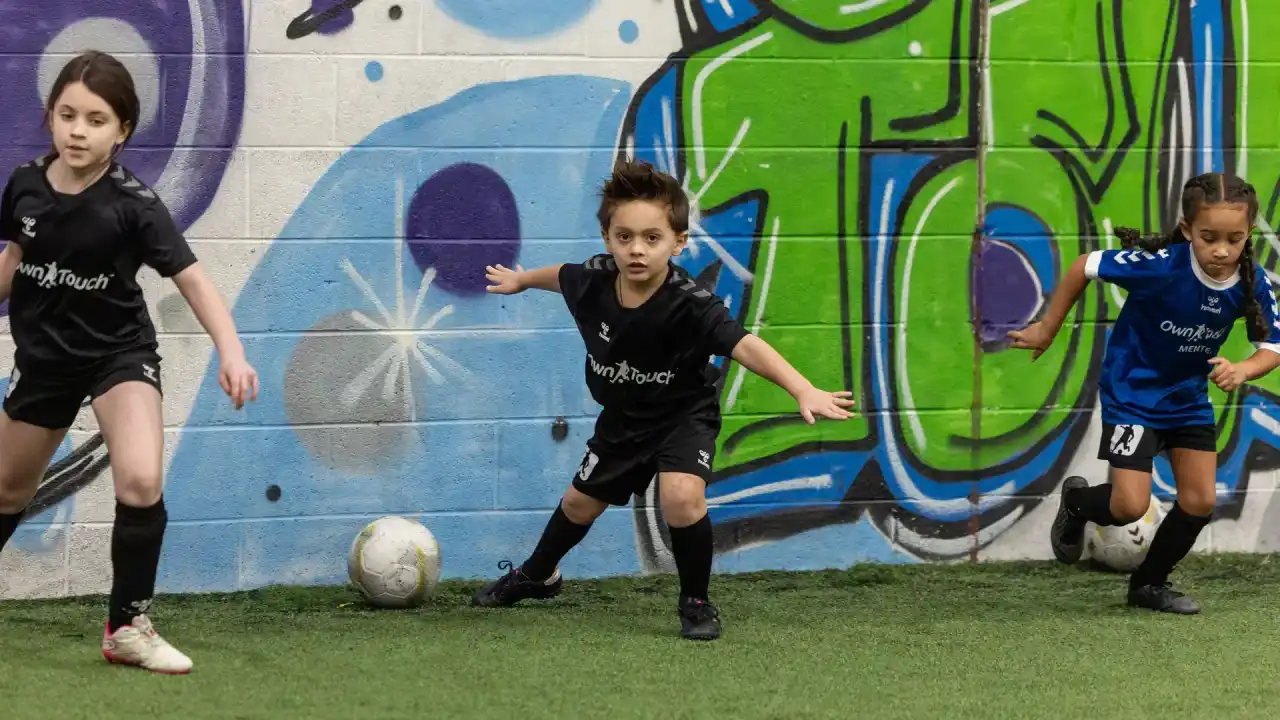 Players training on the indoor pitch at Own Touch Soccer, Charlotte