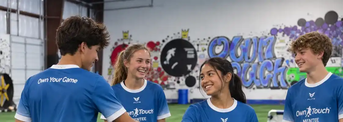 Mentees in blue Own Touch kits laughing together after a drill