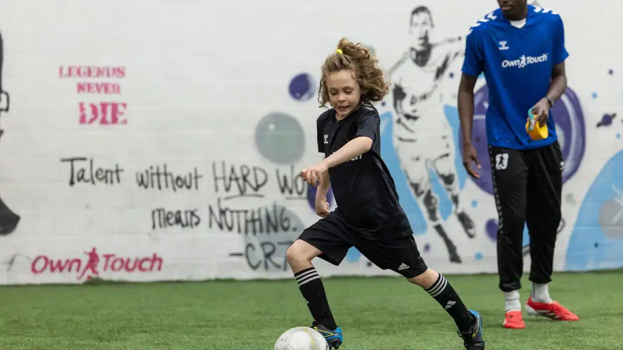 Coach and player during an indoor training session at Own Touch Soccer, Charlotte