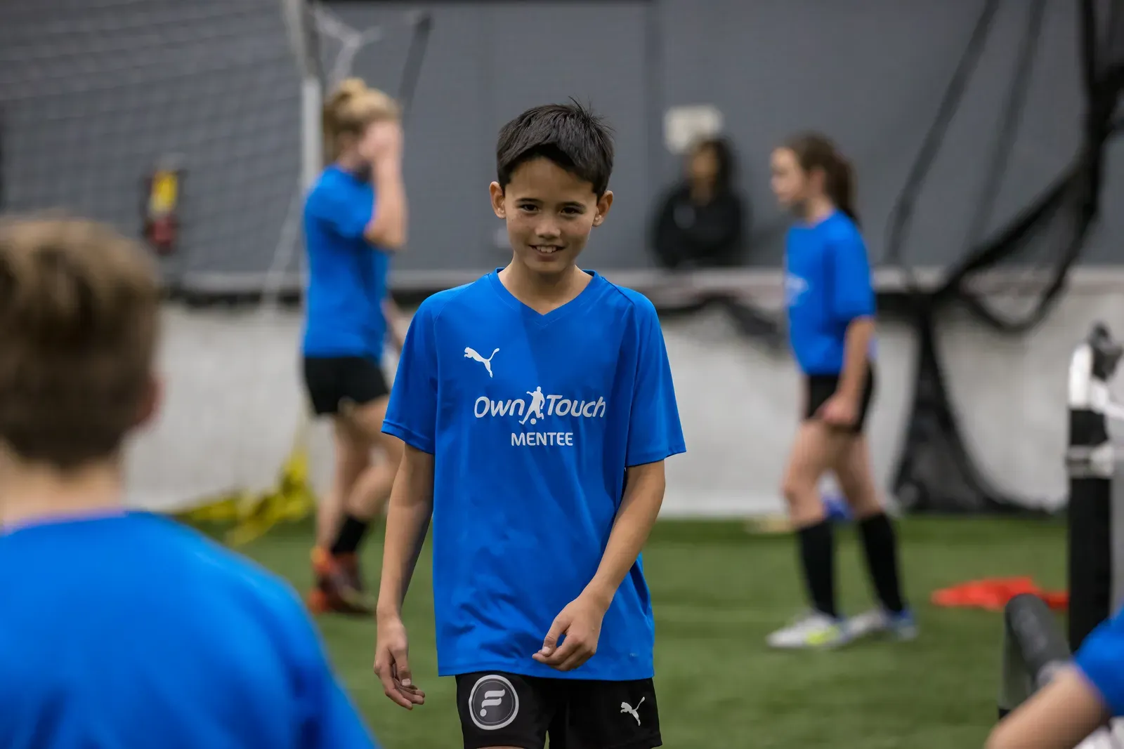 A smiling Mentee in a blue Own Touch shirt during a session