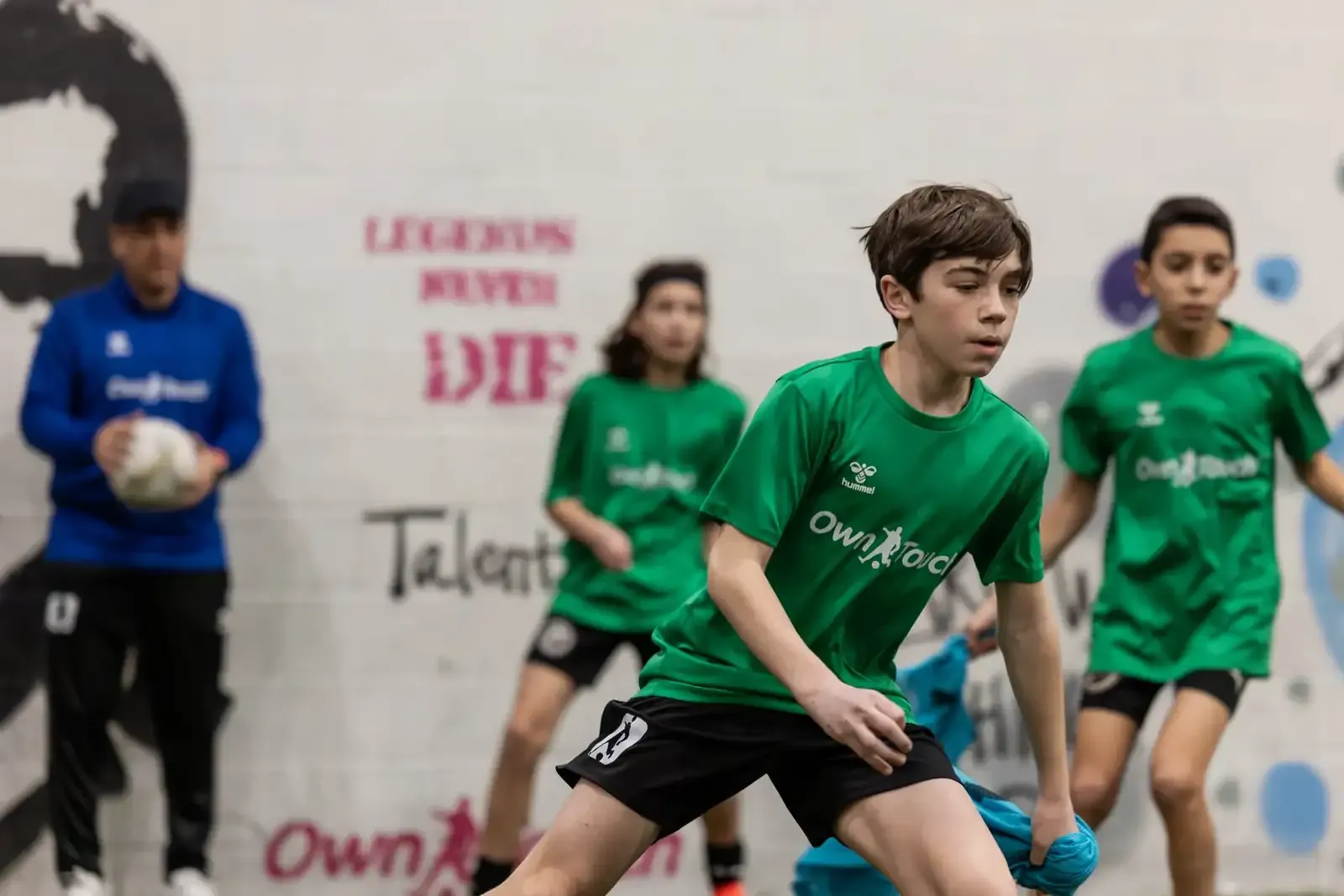Players reacting to a coach’s cue during a small-group agility drill
