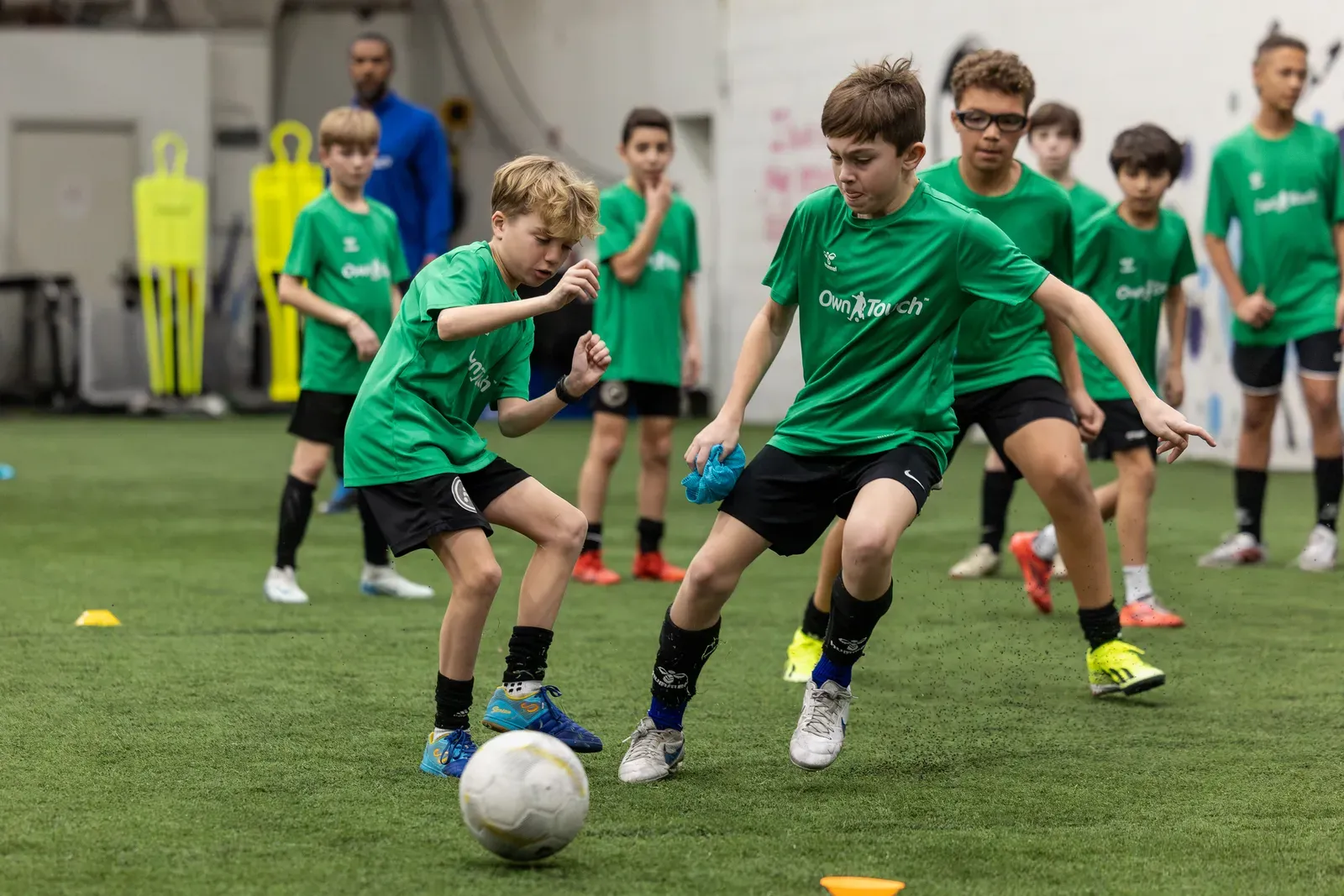 Prospects in green Own Touch shirts competing for the ball