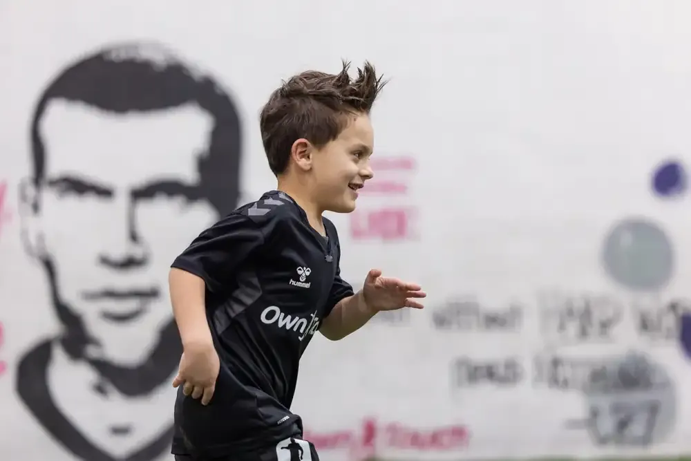 Prospect driving forward with the ball past the studio mural