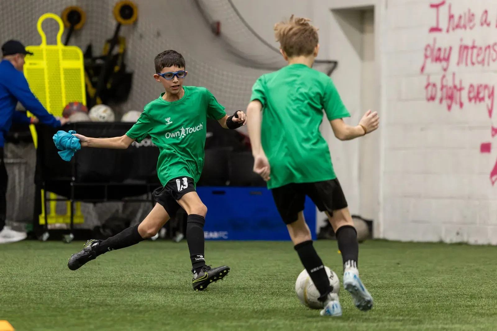 Two Prospects in green shirts competing for the ball in a match-realistic drill
